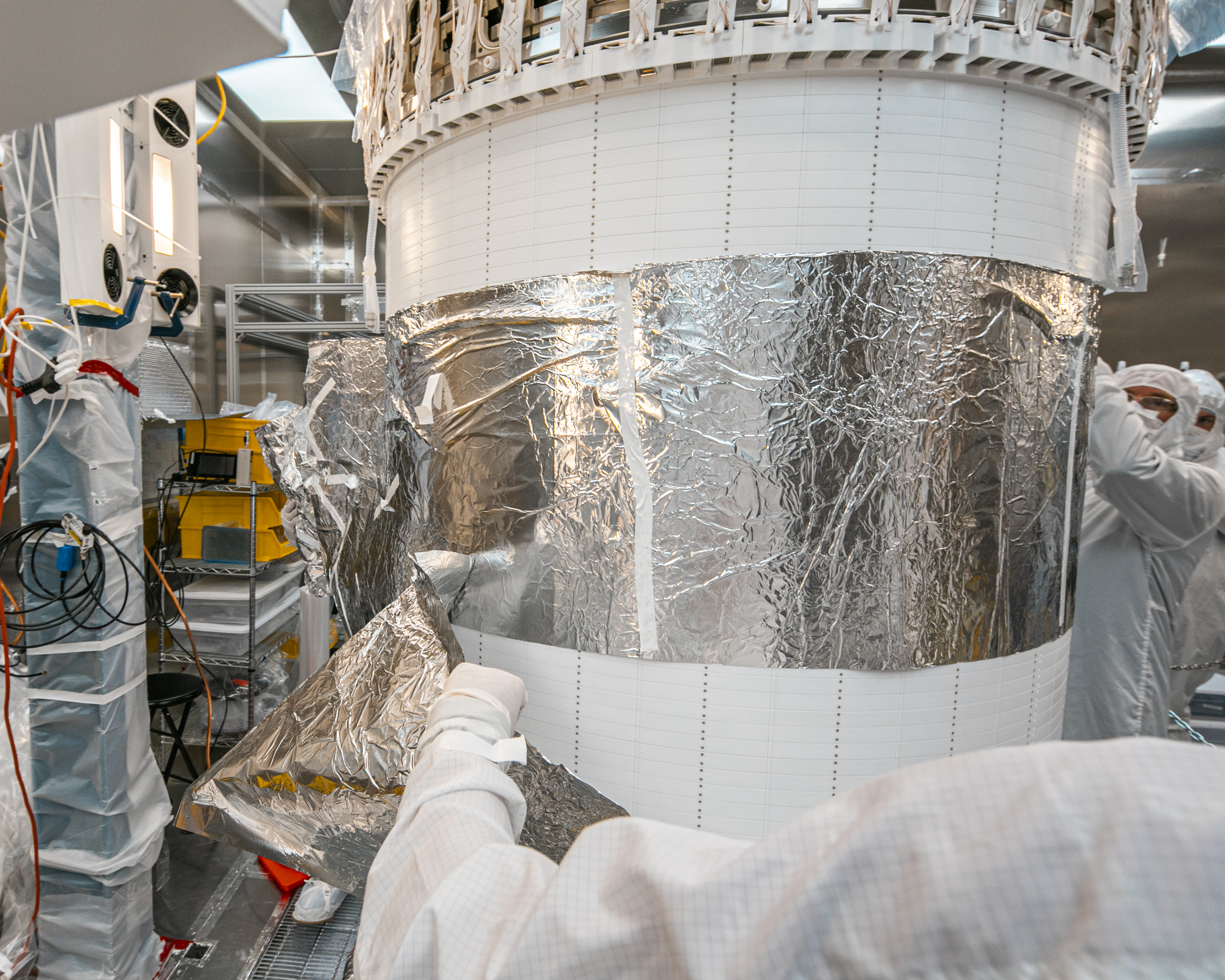 Researcher remove foil wrapped around the time projection chamber.