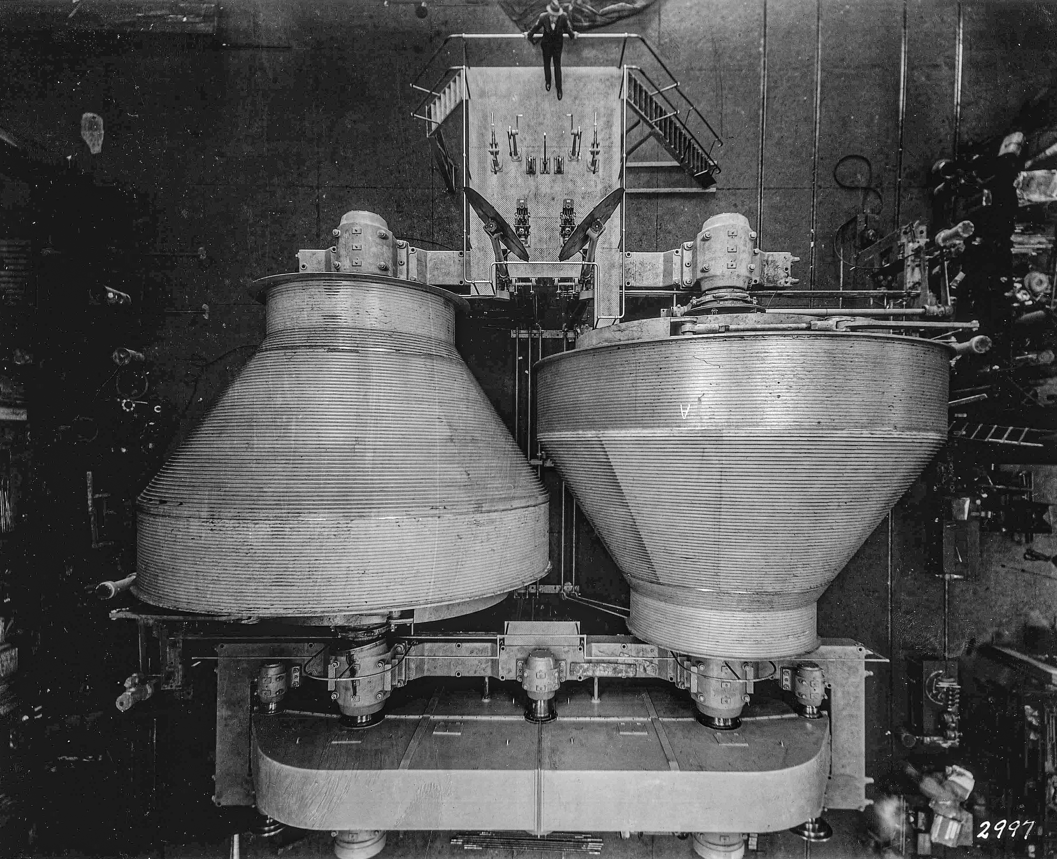 black and white photo of double-drum hoists aligned from above