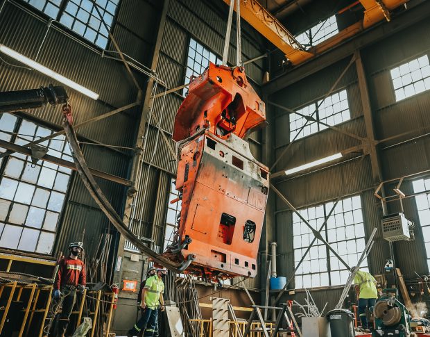 a disassembled portion of a drill rig suspended in the shaft