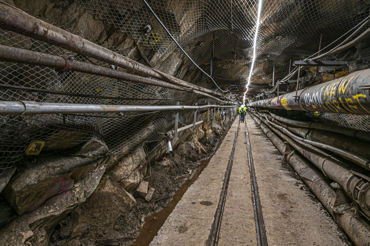 workers walk down the tramway tunnel