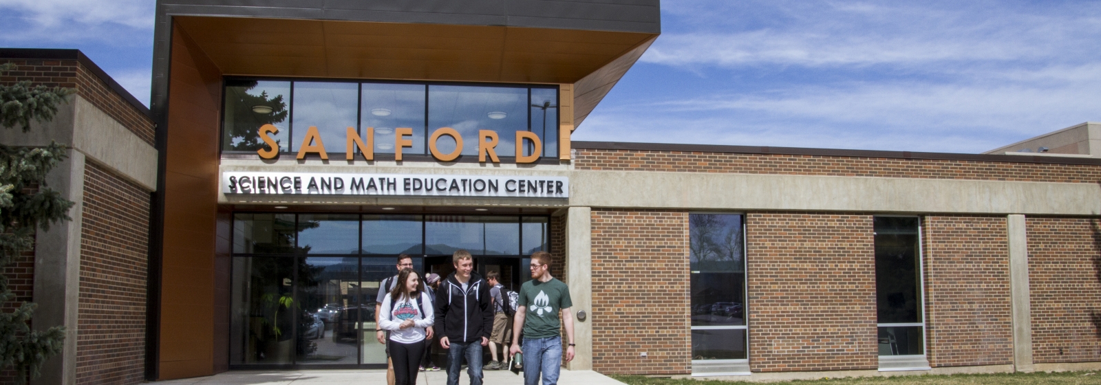 Students walk in front of the Sanford Science Education Center. Black Hills State University