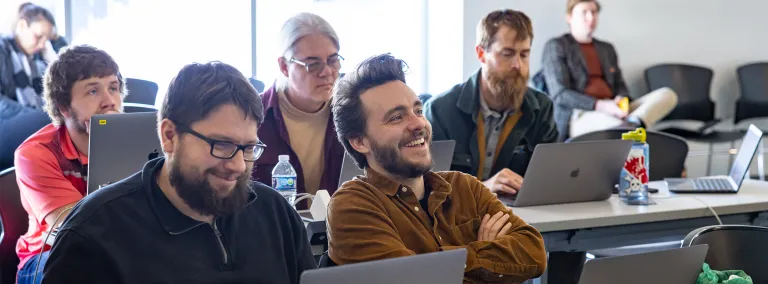 Scientists with open laptops collaborating