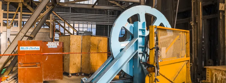 A wheel spins as thick steel cables are replaces in the Ross Shaft.