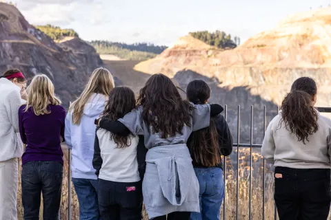 students looking out over the Open Cut in Lead at the Sanford Lab Homestake Visitor Center