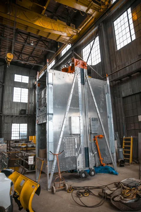 A new cage sits in storage, awaiting installation