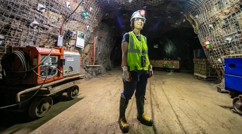 Gina Gibson stands in the middle of an underground drift